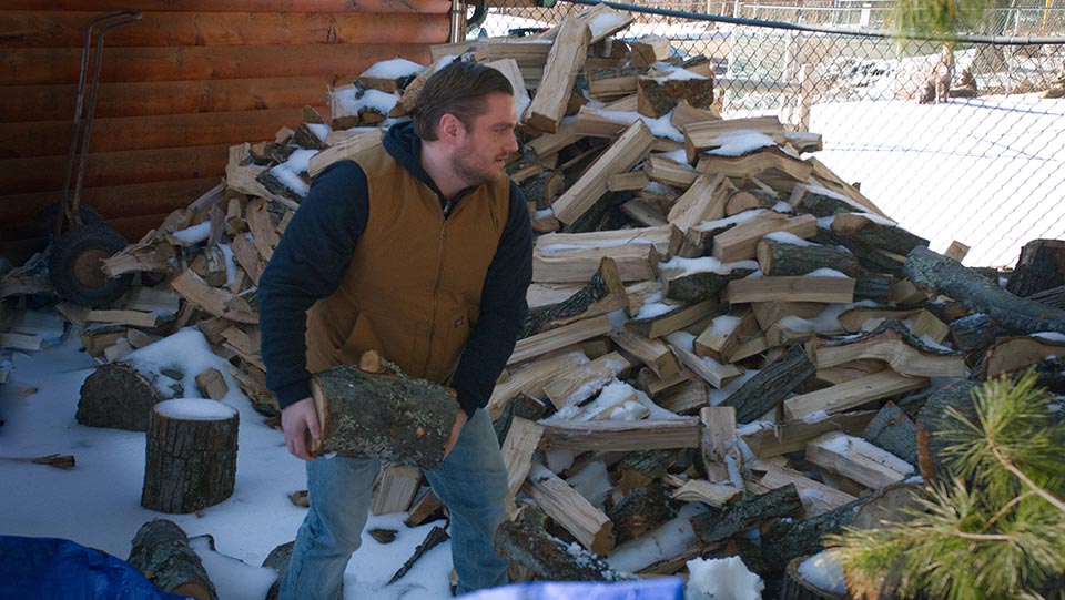 Joe stacking wood